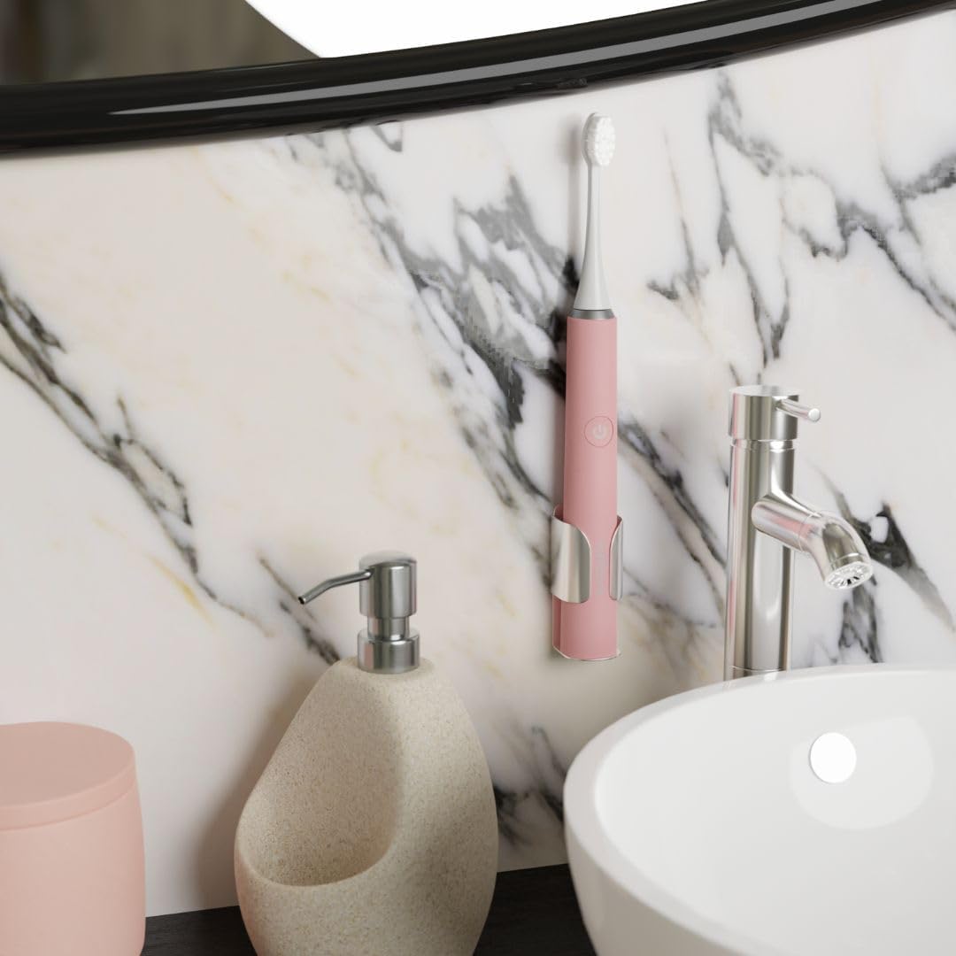 Brosse à dents sonique MyVariations rose posée sur un support dans une salle de bain en marbre